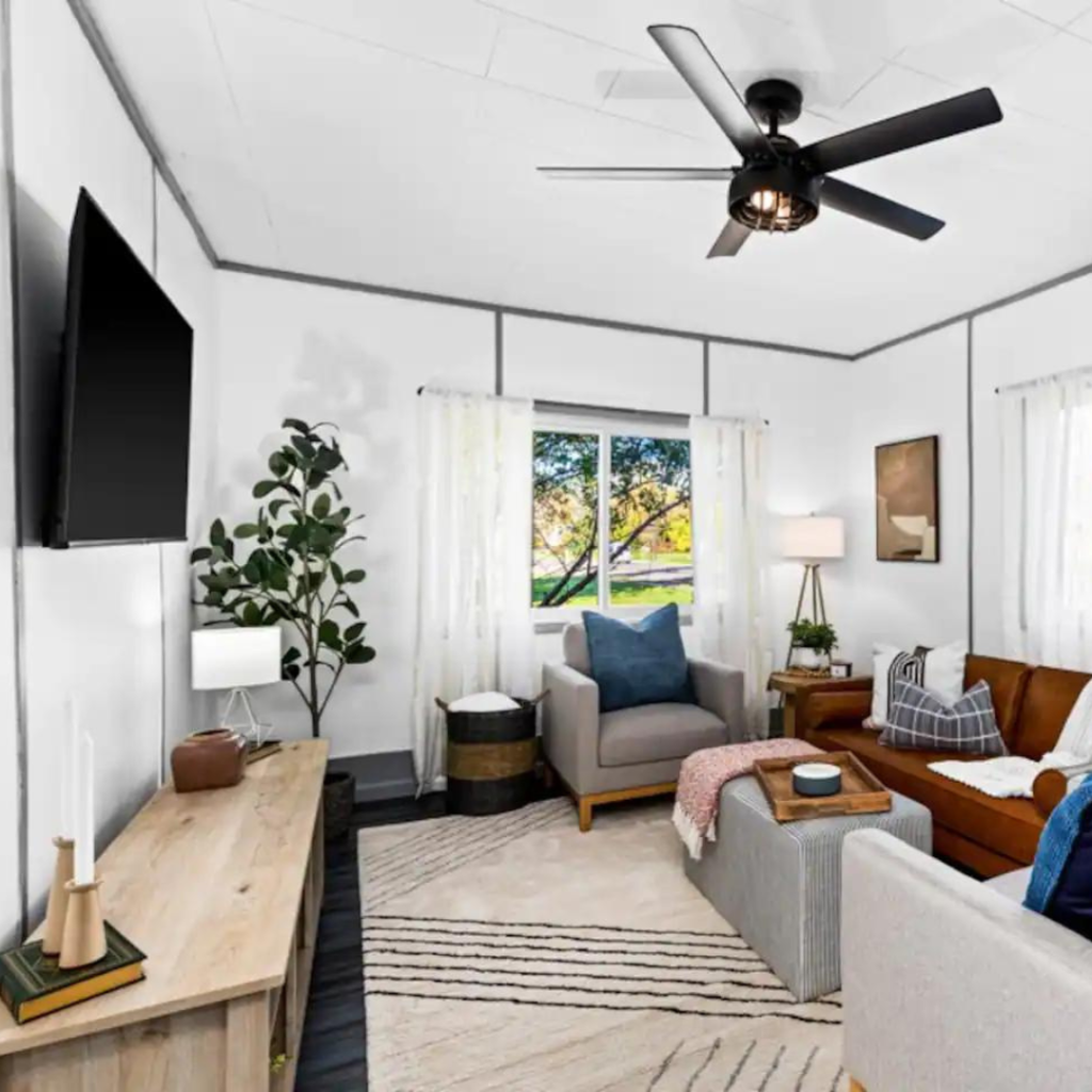 Warm living room with board games, a spacious dining area, and the unique 1930s chimney in our Washburn rental.