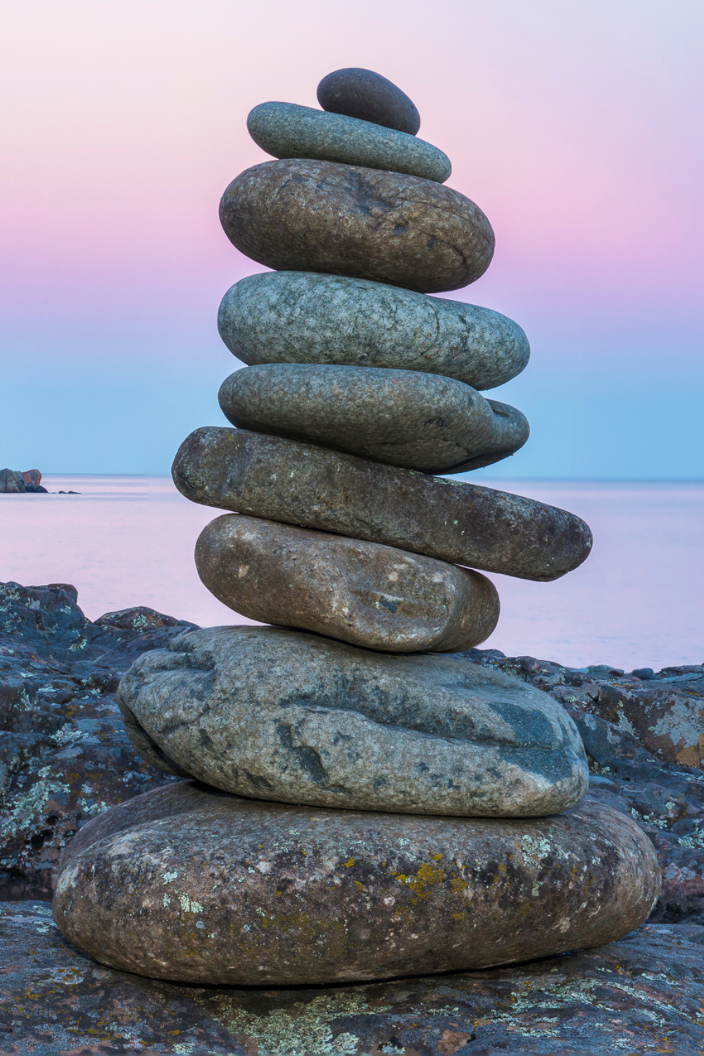 Cairn stone formation with the shimmering backdrop of Lake Superior.